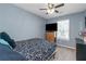 Cozy bedroom features a ceiling fan, light blue walls and a large television at 3268 Rivermist Cv, Decatur, GA 30034