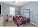 Comfortable bedroom with a metal frame bed, soft carpet and natural light streaming through the window at 3268 Rivermist Cv, Decatur, GA 30034