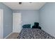Spare bedroom with single bed and black and white comforter with light blue walls at 3268 Rivermist Cv, Decatur, GA 30034