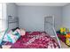 Bedroom featuring a metal frame bed with a colorful comforter, soft carpet, and ample space for a toys at 3268 Rivermist Cv, Decatur, GA 30034