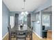 Bright dining area featuring wood floors, a contemporary light fixture, and slider door at 3268 Rivermist Cv, Decatur, GA 30034