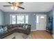 Cozy living room featuring hardwood floors, large windows, and ample seating area at 3268 Rivermist Cv, Decatur, GA 30034