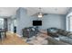 Spacious living room with vaulted ceiling, hardwood floors, large windows, and ample seating area at 3268 Rivermist Cv, Decatur, GA 30034