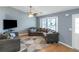 Cozy living room featuring hardwood floors, large windows, and ample seating area at 3268 Rivermist Cv, Decatur, GA 30034