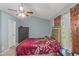 Light filled bedroom featuring a vaulted ceiling, large windows and a ceiling fan at 3268 Rivermist Cv, Decatur, GA 30034