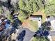 This is an aerial view of a home including the roof, driveway and a wooded yard at 2921 Oakwilde Ct, Snellville, GA 30039