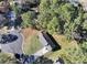 This is an aerial view of a home including the roof, driveway, wooded yard and street at 2921 Oakwilde Ct, Snellville, GA 30039