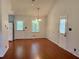 Bright dining area featuring wood floors, a chandelier, and views of the backyard through a window at 2921 Oakwilde Ct, Snellville, GA 30039