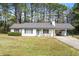 Charming single-story home with a light blue door, a covered carport, and a well-maintained front yard at 2921 Oakwilde Ct, Snellville, GA 30039