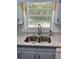 Kitchen sink with granite countertops, stainless steel faucet, with natural light from the window at 2921 Oakwilde Ct, Snellville, GA 30039