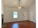 Inviting living room with a vaulted ceiling, wood floors, and a large window providing natural light at 2921 Oakwilde Ct, Snellville, GA 30039
