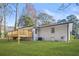 A side view of the backyard highlighting the wooden deck and the brickwork on the house's exterior at 1403 Centra Villa Dr, Atlanta, GA 30311