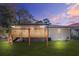 A side view of the backyard highlighting the wooden deck and the brickwork on the house's exterior at dusk at 1403 Centra Villa Dr, Atlanta, GA 30311