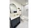 Stylish bathroom featuring black and white tile, a bathtub and a modern vanity with gold accents at 1403 Centra Villa Dr, Atlanta, GA 30311