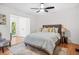 Bedroom features a large bed with a patterned rug, ceiling fan, and lots of natural light at 1403 Centra Villa Dr, Atlanta, GA 30311