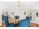 Chic dining room with a round table, elegant blue chairs, and modern lighting at 1403 Centra Villa Dr, Atlanta, GA 30311