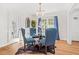 Cozy dining area with a round table, tufted blue chairs, and natural light at 1403 Centra Villa Dr, Atlanta, GA 30311