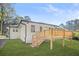 Backyard view of a home with a new deck, landscaping, and freshly painted white brick at 1403 Centra Villa Dr, Atlanta, GA 30311