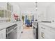 Bright kitchen featuring white cabinets, granite countertops, and dining area view at 1403 Centra Villa Dr, Atlanta, GA 30311