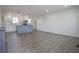 An open floor plan features new light-colored floors and a new kitchen with an island and pendant lights at 226 Lipham St, Bowdon, GA 30108