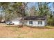 A cozy one-story house with white siding, a well-kept lawn, and a car parked in the driveway at 2931 Oakwilde Ct, Snellville, GA 30039