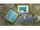 An aerial view of the pool, clubhouse, tennis courts and parking lot of the community at 310 Mulberry Manor Ct, Johns Creek, GA 30005