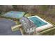 A close aerial view of the community clubhouse, pool, tennis courts and parking lot at 310 Mulberry Manor Ct, Johns Creek, GA 30005