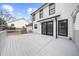 Spacious backyard with white deck, black framed windows, and white siding at 310 Mulberry Manor Ct, Johns Creek, GA 30005