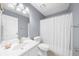 Bright bathroom with a single vanity, toilet, and shower with white curtain at 310 Mulberry Manor Ct, Johns Creek, GA 30005