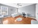 Well-lit bedroom with hardwood floors and a comfortable workspace by the windows at 310 Mulberry Manor Ct, Johns Creek, GA 30005