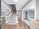 Bright entryway with hardwood floors, staircase, and view into the dining area at 310 Mulberry Manor Ct, Johns Creek, GA 30005