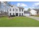 Charming white two-story home with a well-manicured lawn and black trim accents at 310 Mulberry Manor Ct, Johns Creek, GA 30005