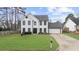 Charming two-story home with a well-manicured lawn, a two-car garage, and a welcoming front entrance at 310 Mulberry Manor Ct, Johns Creek, GA 30005