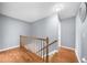 Upstairs hallway showcasing hardwood floors and neutral paint at 310 Mulberry Manor Ct, Johns Creek, GA 30005