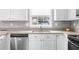Bright kitchen showcasing stainless steel appliances, stone counters, and a window at 310 Mulberry Manor Ct, Johns Creek, GA 30005