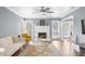 Sun-filled living room with fireplace, white trim, and hardwood flooring at 310 Mulberry Manor Ct, Johns Creek, GA 30005