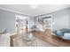 Bright living room with hardwood floors and blue accent chairs with staircase access at 310 Mulberry Manor Ct, Johns Creek, GA 30005