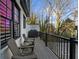 Relaxing balcony with outdoor seating and a grill, perfect for enjoying the view and outdoor cooking at 145 Canton St, Alpharetta, GA 30009