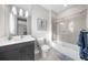 Modern bathroom with dark vanity, white marble countertop, and tiled shower with glass door at 145 Canton St, Alpharetta, GA 30009