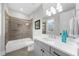 Well-lit bathroom with shower-tub combo, white vanity, and modern fixtures at 145 Canton St, Alpharetta, GA 30009