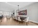 Bright dining room with modern light fixture, open to the living room with hardwood floors at 145 Canton St, Alpharetta, GA 30009