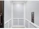 Interior view of a modern residential elevator, featuring paneled walls and accessible controls at 145 Canton St, Alpharetta, GA 30009