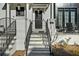 This lovely porch has steps leading up to the black iron gate and front door with a modern address at 145 Canton St, Alpharetta, GA 30009