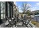 Charming front porch seating area on white brick townhome, perfect for enjoying the neighborhood views at 145 Canton St, Alpharetta, GA 30009