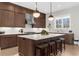 Modern kitchen features stainless steel appliances, a large island with seating, and pendant lighting at 145 Canton St, Alpharetta, GA 30009