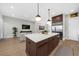 Open kitchen layout with large island, modern appliances, and seamless flow into the living area at 145 Canton St, Alpharetta, GA 30009