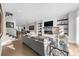 Bright living room features a fireplace with a TV above, built-in shelves, stairs, and modern light fixtures at 145 Canton St, Alpharetta, GA 30009