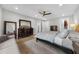 Cozy main bedroom with hardwood floors, a dresser, and a comfortable sitting area for relaxation at 145 Canton St, Alpharetta, GA 30009