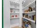 Well-organized pantry with stocked shelves and convenient storage solutions, including paper towels and food containers at 145 Canton St, Alpharetta, GA 30009