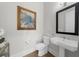 Elegant powder room featuring a modern vanity, stylish mirror, and tasteful artwork enhancing the space at 145 Canton St, Alpharetta, GA 30009